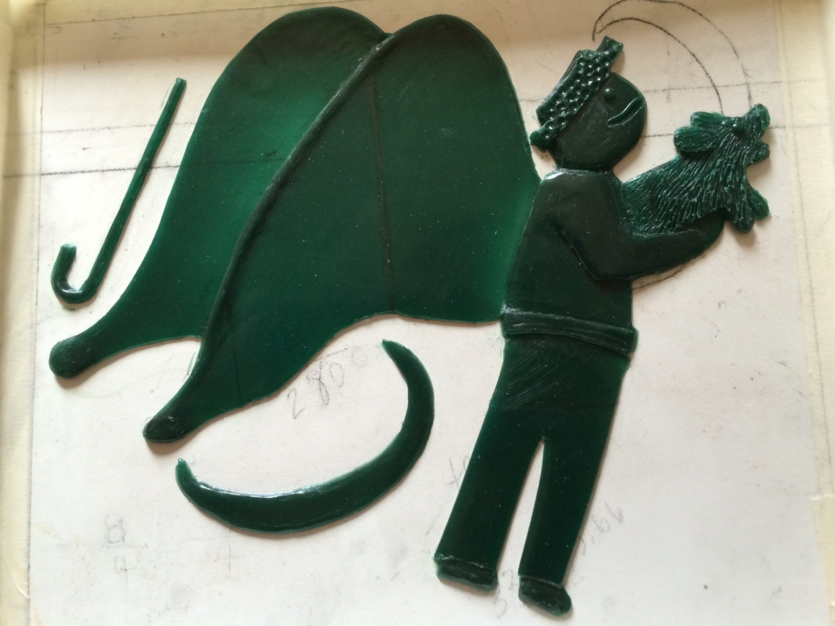 the green wax sculpture is thin and a bit transparent. the image of the man and dog is very simple without much detail but it still conveys the feeling of tenderness.